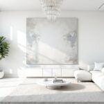 Modern white living room with abstract art and natural light, showcasing the elegance of white interior design.
