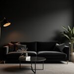 Elegant black living room with velvet sofa, gold accents, and warm natural light
