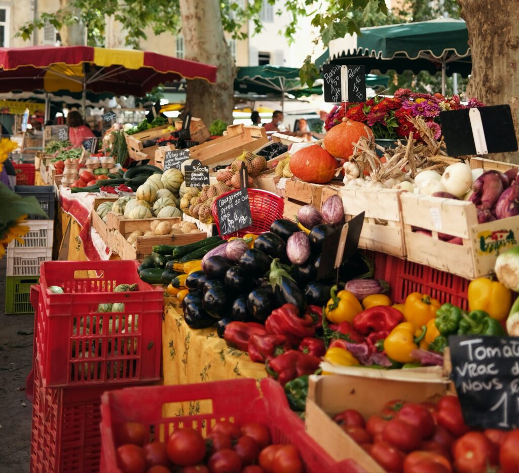 vibrant farmers' market with people buying fresh, locally grown produce