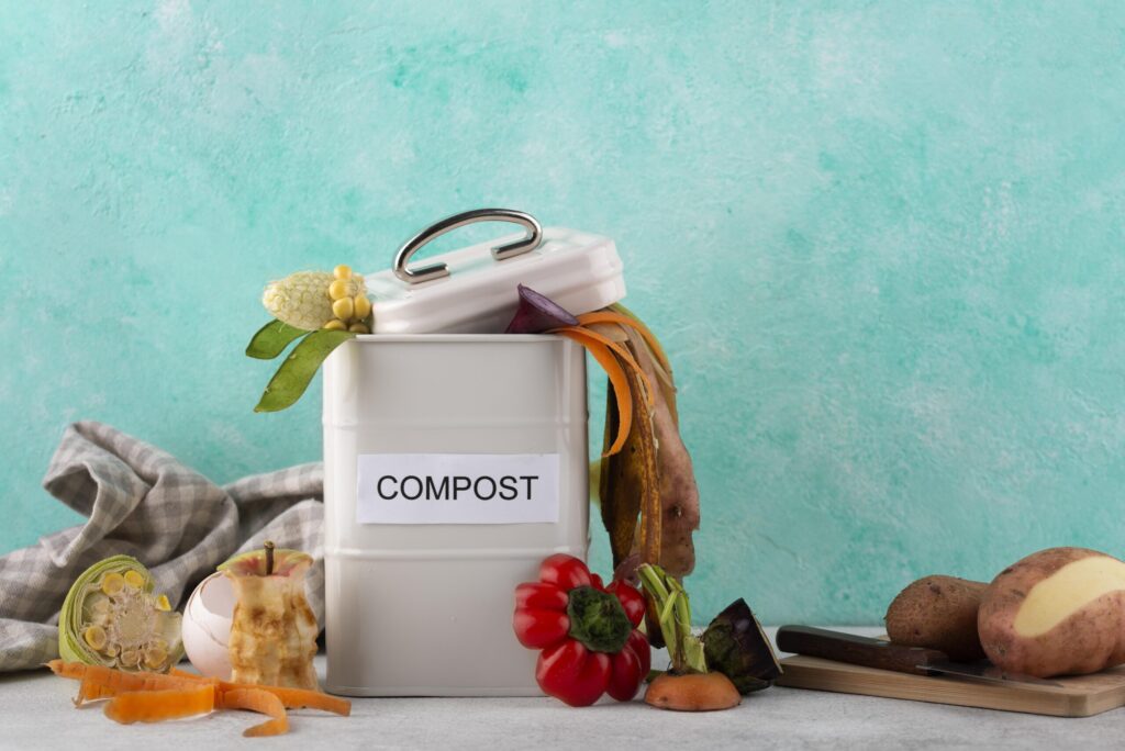 compost bin filled with kitchen scraps and dry garden clippings